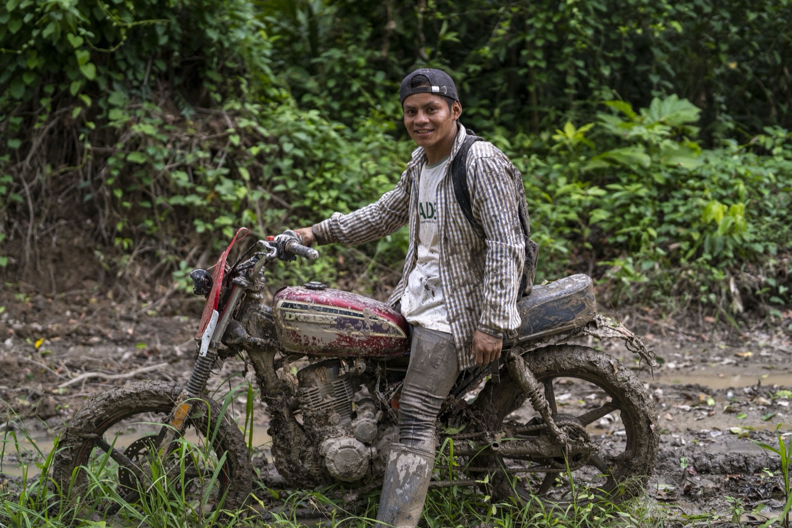 Young man on motorbike in mud