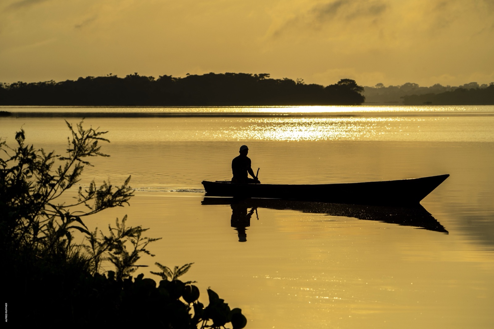 Canoe silhouette at golden sunset