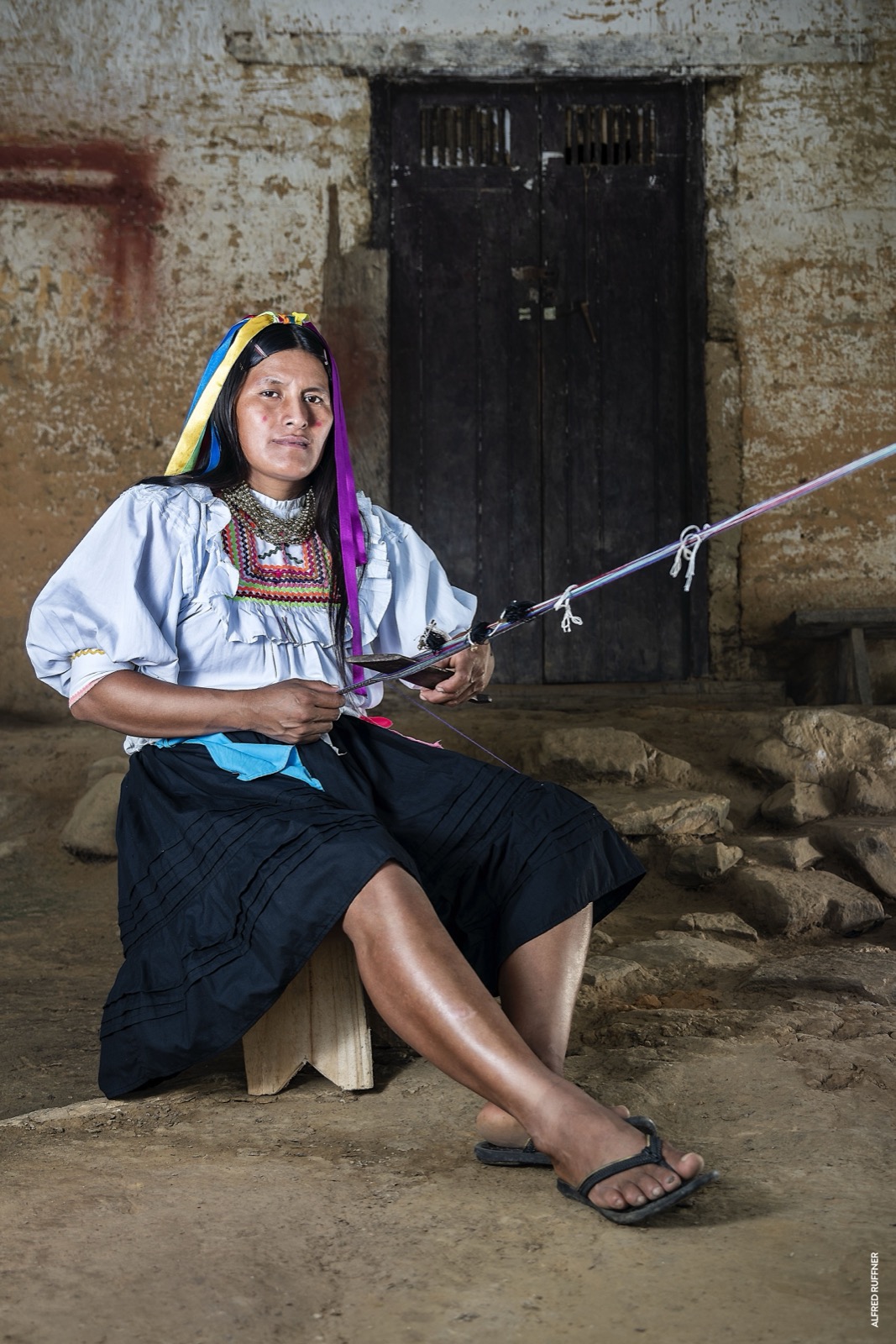 Indigenous woman weaving with backstrap loom