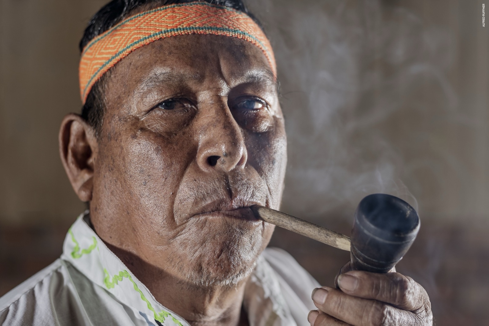 Indigenous elder smoking pipe portrait