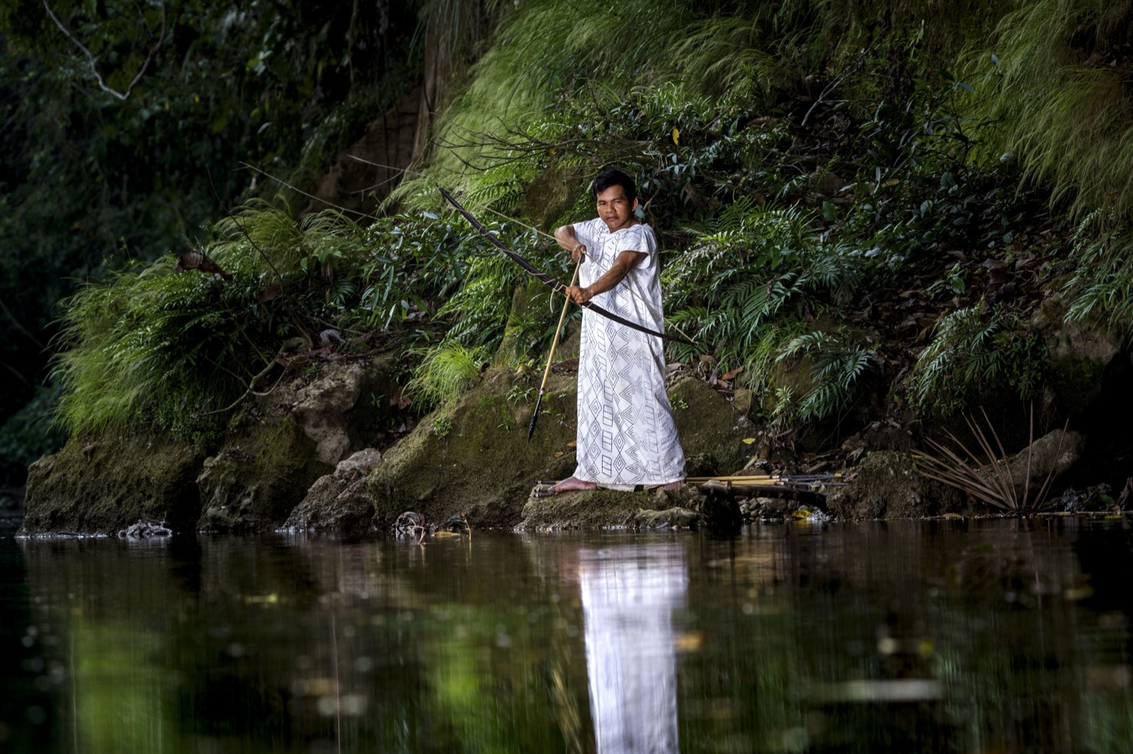 Indigenous woman fishing by the river
