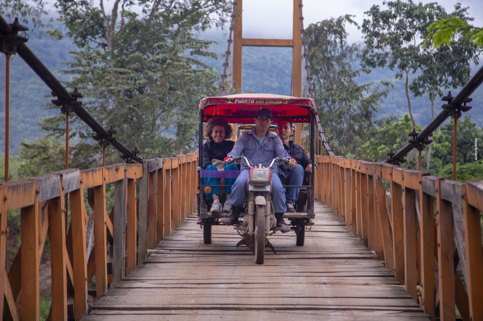 Mototaxi crossing hanging bridge