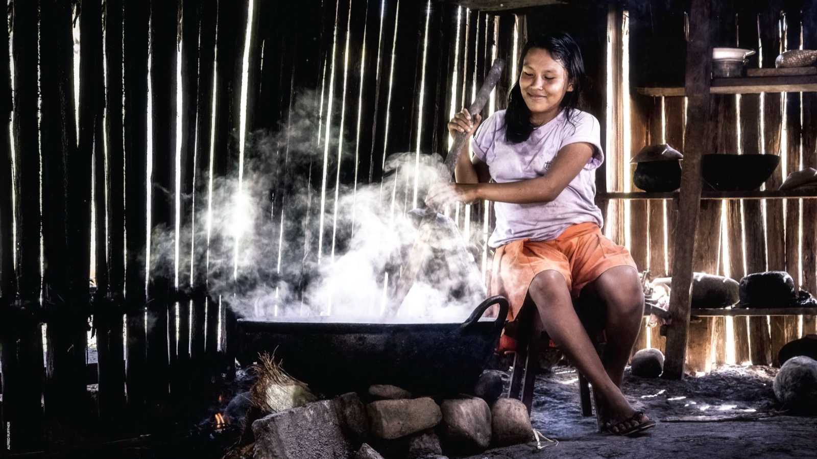 Young woman cooking in traditional kitchen