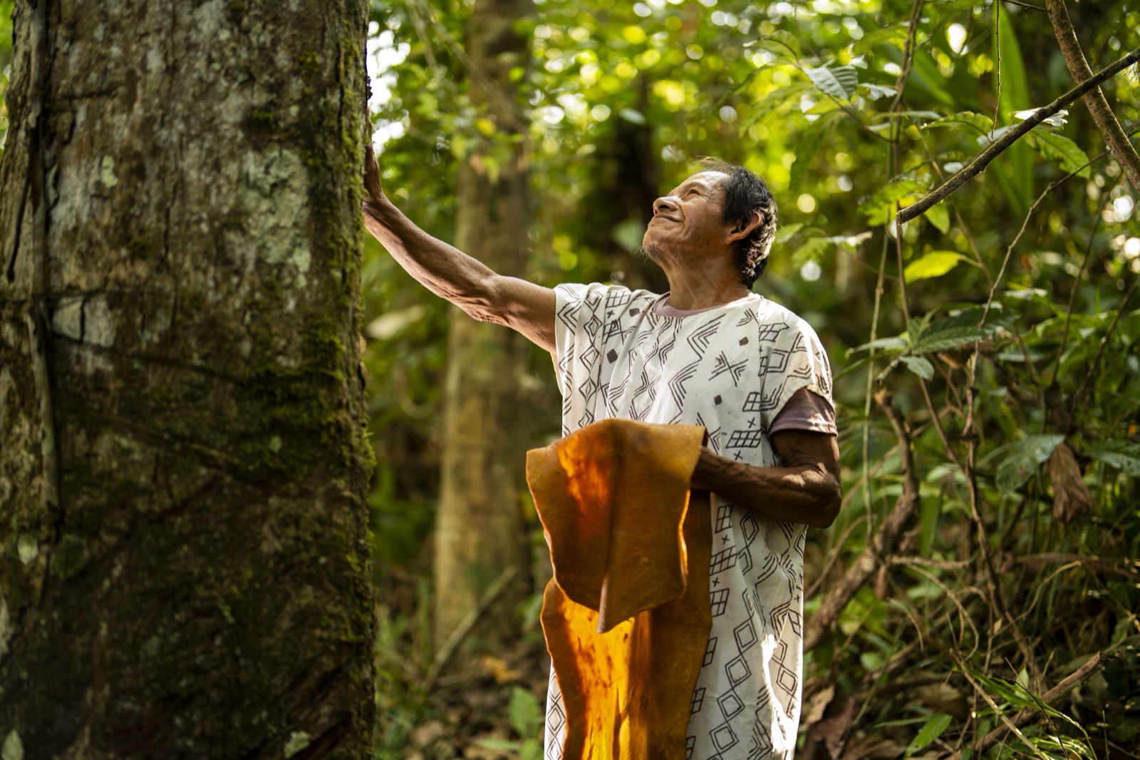 Indigenous man with cushma in forest