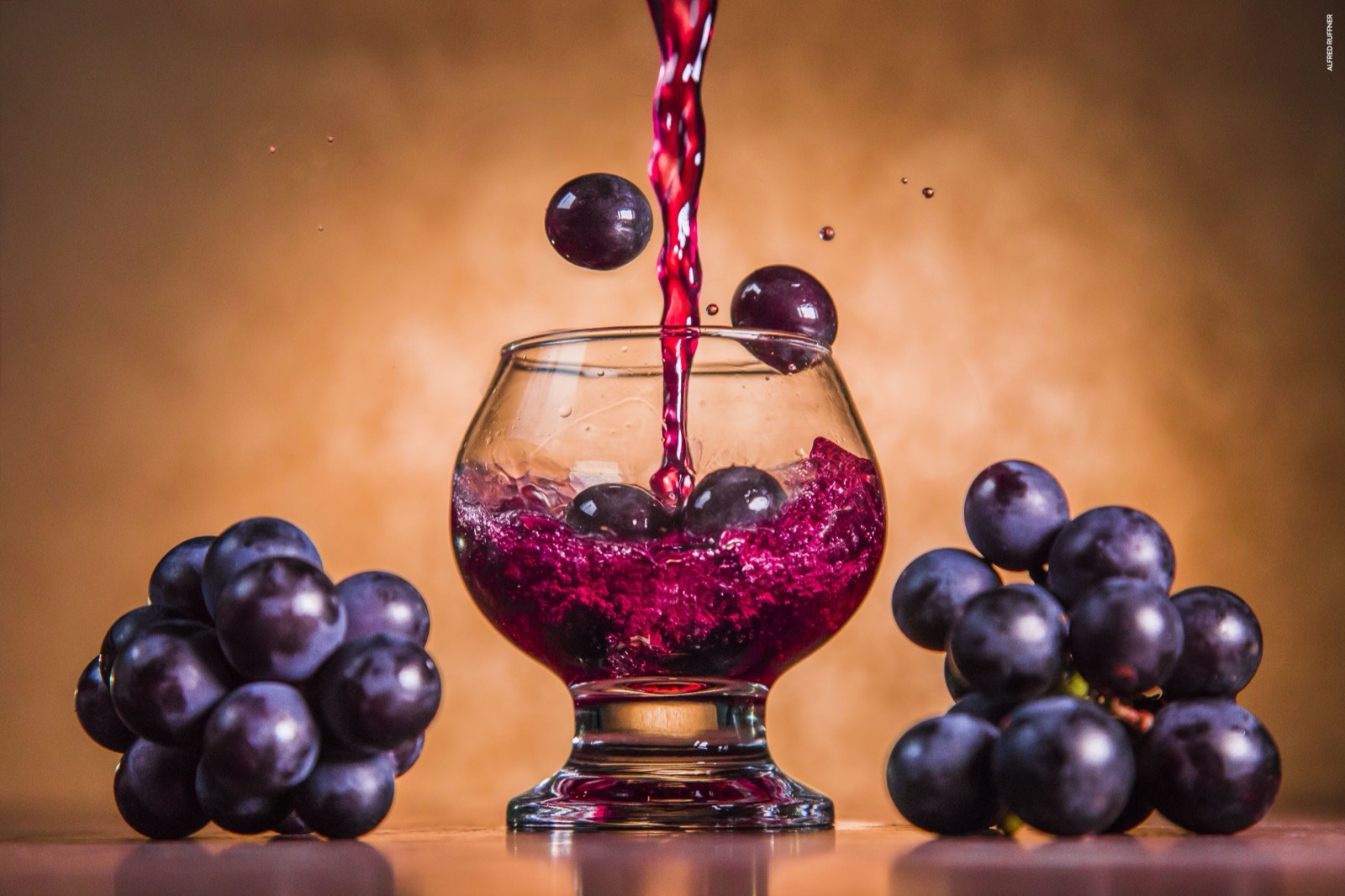 Wine glass with grapes product shot